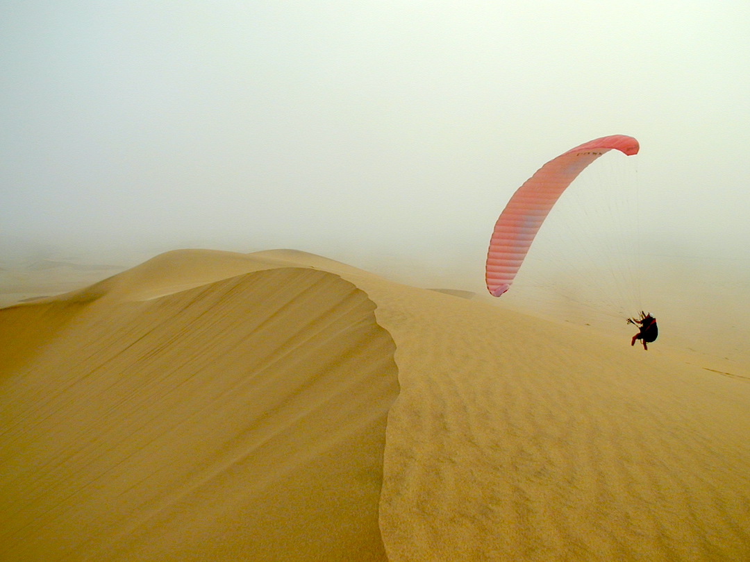Dave practicing with the paraglider on the sand dunes in Namibia
