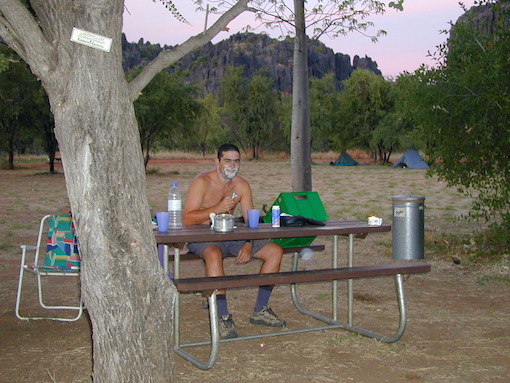 Dave having a shave at a picnic table in a National Park campsite in Western Australia.