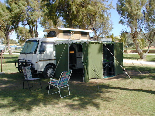 Camper van plus awning parked in a campsite in Western Australia.