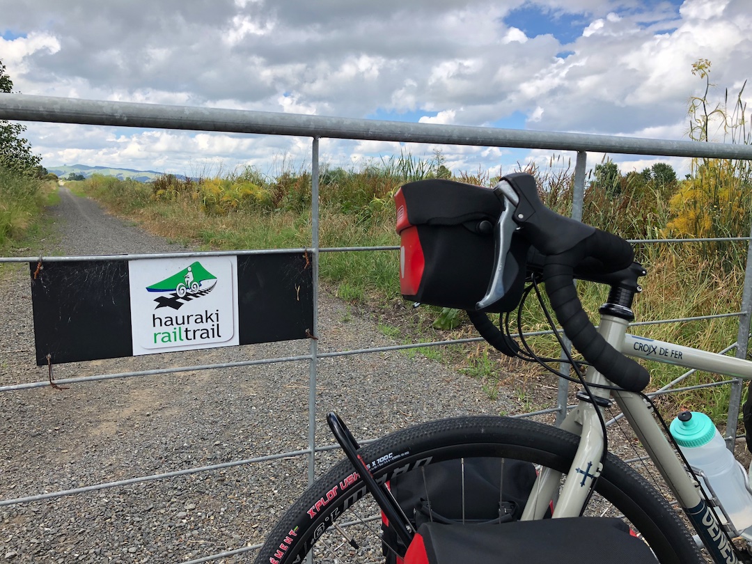 Bicycle parked next to a gate on the Hauraki Rail Trail