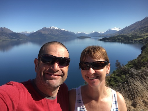 David and Sharon Schindler with backdrop of Lake Wakatipu and snow topped mountains.