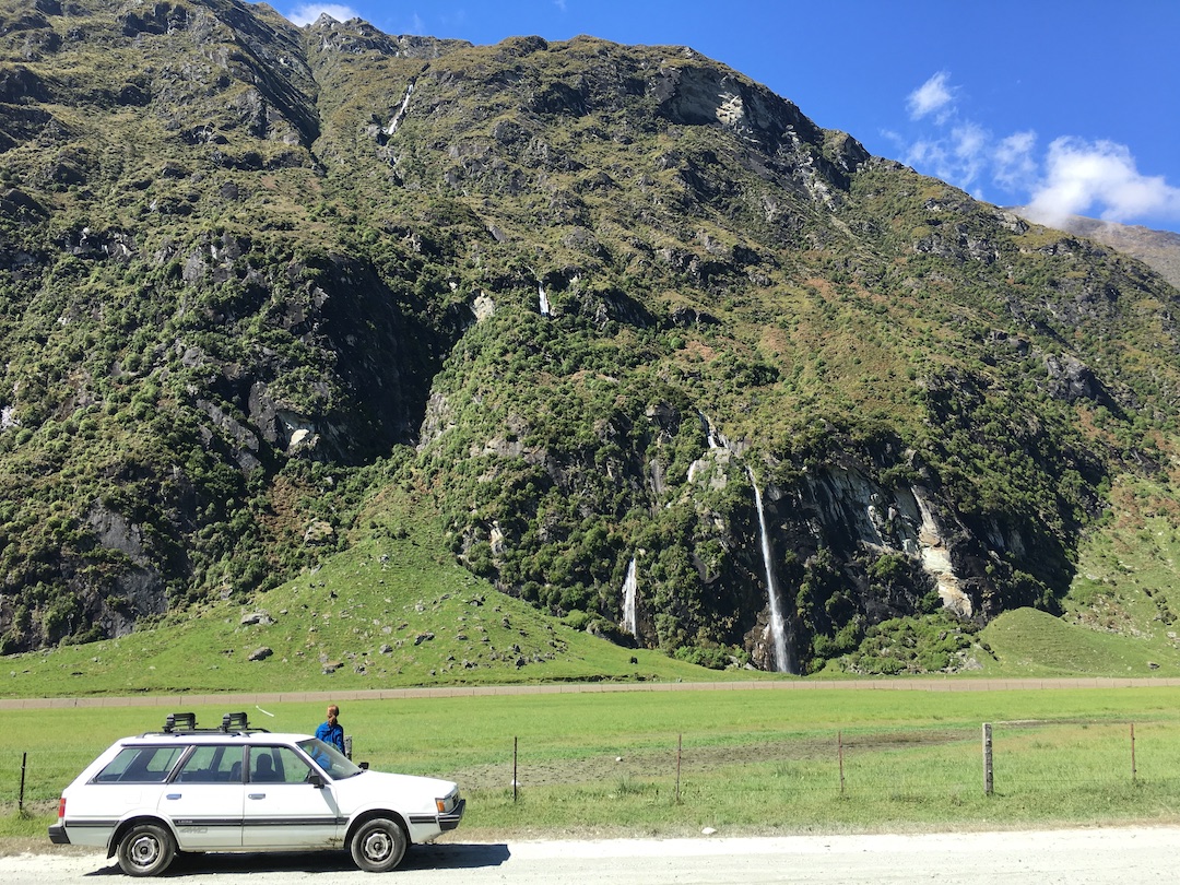 Subaru parked on gravel road in Matukituki Valley New Zealand