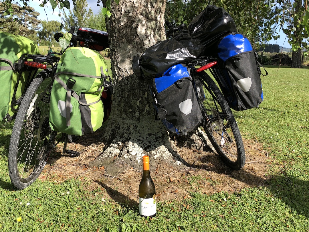 Bikes and bottle of wine at Te Araroa campsite